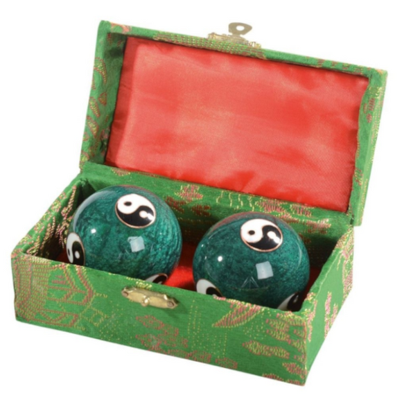 Musical polished steel balls. Green Yin Yang texture